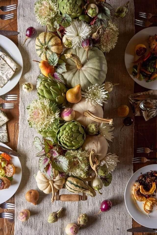 A beautifully arranged table showcases an assortment of fresh vegetables and fruits, enticingly vibrant and ready to be savored.