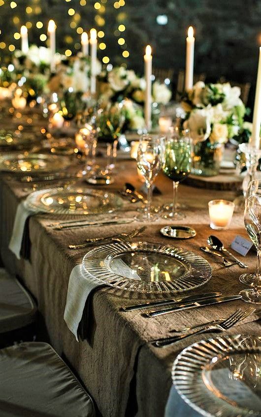 An exquisite long table featuring sophisticated white and gold place settings, complemented by metallic accents.