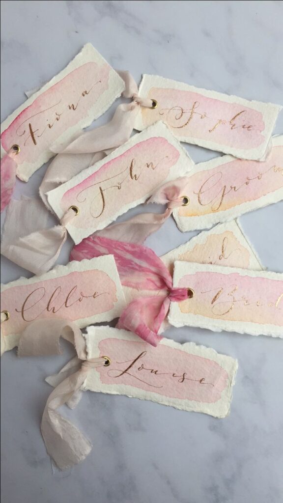 Make your guests feel special with these personalized pink and gold place cards, hand-painted with beautiful calligraphy.